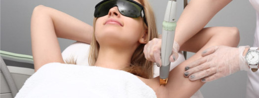 Woman having underarm Laser hair removal epilation.